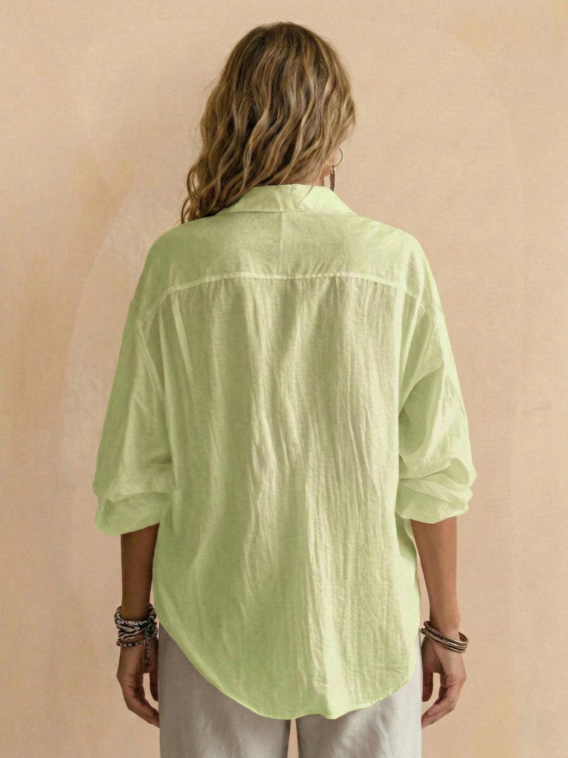 Lightweight 100% cotton popover blouse with relaxed oversized fit, classic collar, and tunic-length curved hem.