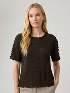 Floral jacquard pleated top with 3D floral texture, flutter sleeves, and relaxed A-line silhouette