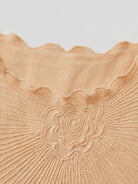 Floral jacquard pleated top with 3D floral texture, flutter sleeves, and relaxed A-line silhouette