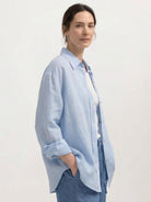 100% linen dropped-shoulder shirt with oversized fit, side slits, and rollable cuffs