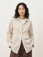 100% linen pinstripe shirt with loose fit, drop shoulders, long sleeves, and curved hem