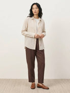 100% linen pinstripe shirt with loose fit, drop shoulders, and long sleeves with button cuffs