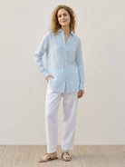 100% linen pinstripe shirt with loose fit, drop shoulders, full button placket, and long sleeves for breathable comfort.