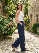 100% linen wide-leg pants with high-rise elastic waistband and drawstring tie, floor-length, side pockets, and relaxed fit