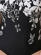 Curve-fit open-back swimsuit with scoop front, adjustable straps, and diagonal back panels