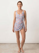 Ruched wrap one-piece swimdress with adjustable straps and tie-front skirt in matte fabric
