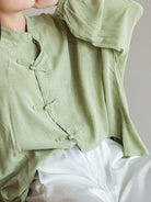 Oversized linen-cotton tang knot blouse with batwing sleeves and asymmetric hem