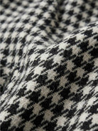 Black and white houndstooth commuter blazer with structured shoulders and relaxed fit
