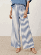 Woman wearing black striped wide-leg co-ord set with oversized top and palazzo pants with elastic waist and side pockets