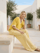 Woman wearing striped wide-leg co-ord set with oversized top and palazzo pants in multiple colors