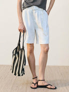 White 100% linen belted high-rise wide-leg shorts with matching fabric belt and front pleats for breathable summer wear