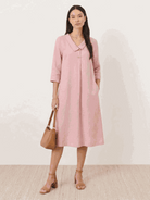 Woman wearing a relaxed fit linen-look midi dress with 3/4 sleeves and side pockets in navy