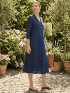 Woman wearing navy linen-look midi dress with relaxed fit and button detail