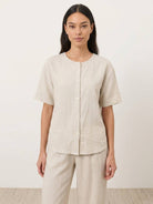 100% cotton two-piece set with button-front shirt and wide-leg pants in solid soft colors