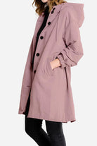Water resistant oversized windbreaker rain jacket in mauve with hood and button closure