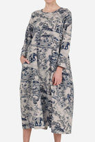 Woman wearing a loose fit Japanese Porcelain Print midi dress with 3/4 sleeves and two front pockets