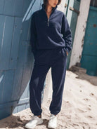 Cotton-blended two-piece tracksuit with high collar, zip front, relaxed fit, and straight-leg pants