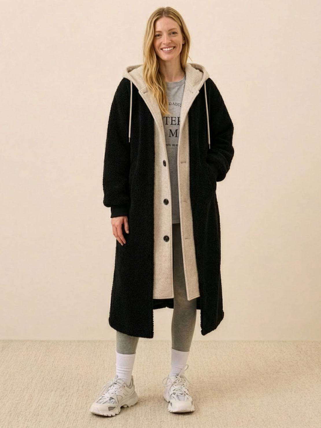 Woman wearing black oversized sherpa-lined long coat with hoodie, casual outfit for everyday wear oversized coat.