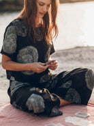 Woman wearing soft-tailored loose fit co-ord set with wide-leg cotton trousers in light neutral color