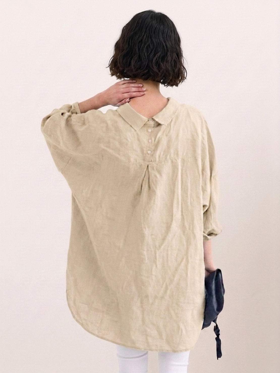 Oversized linen shirt in white with relaxed fit and button detailing on back