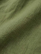 Close-up of soft green pure linen fabric texture for age-defying shirt