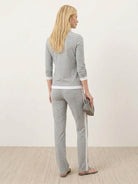Woman wearing sleek contrast zip two-piece outfit with zip details and flattering silhouette