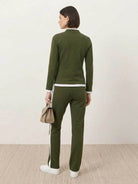women wearing sleek contrast zip two-piece outfit standing against white background