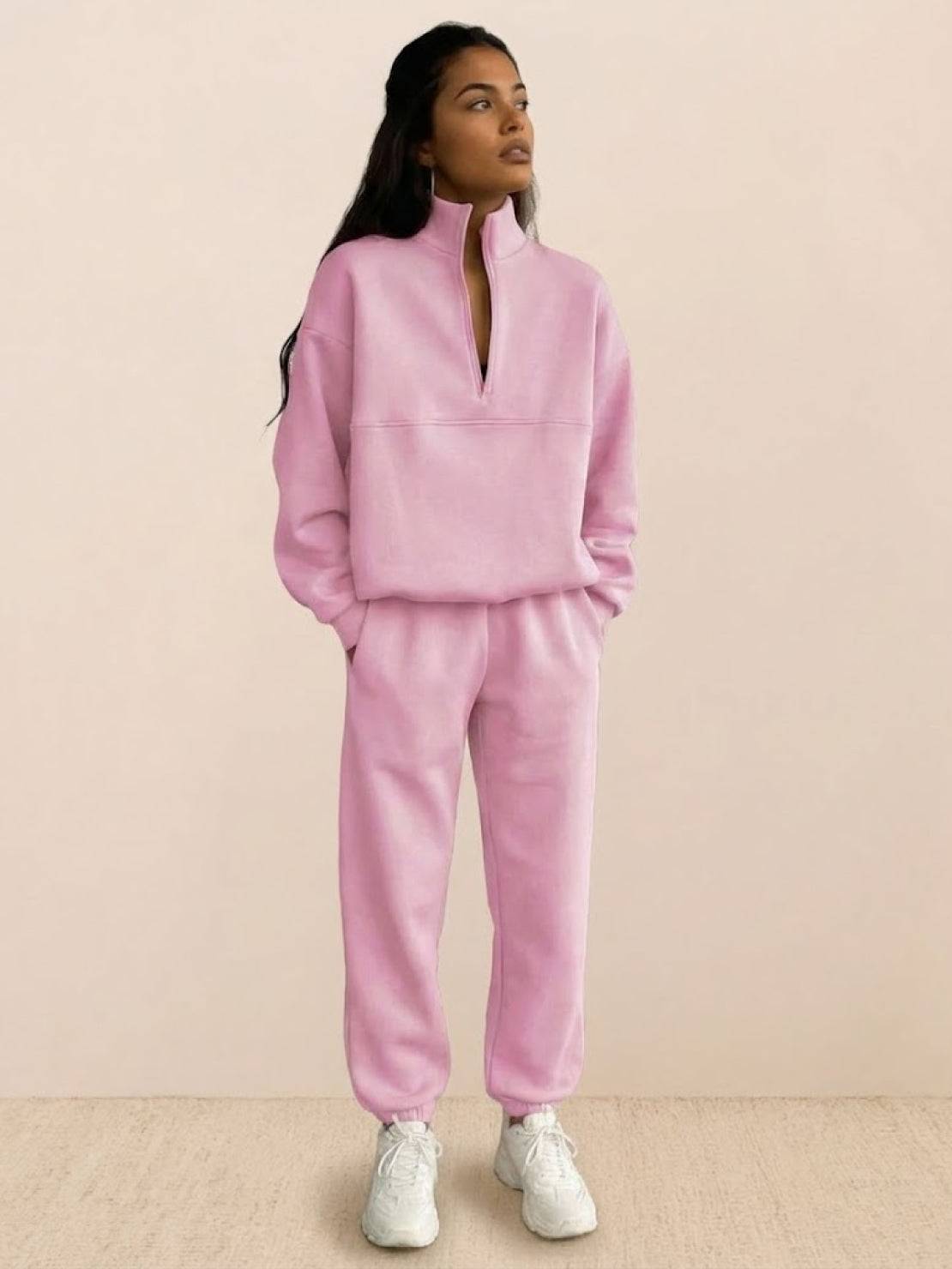 woman wearing a cotton-blended two-piece tracksuit with high collar and deep zipper showing casual athleisure style