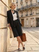 Woman wearing a polished blazer and high-waisted shorts two-piece set in durable cotton and terylene blend