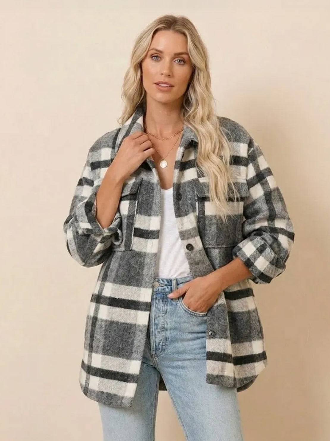 Woman wearing comfy flannel classic button-down shirt in gray and white plaid design.
