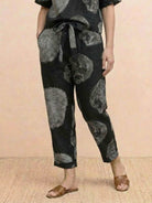 Pair of straight-leg cotton linen monochrome pants with adjustable drawstring waist and natural texture
