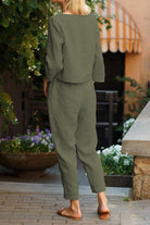 Back view of woman wearing relaxed cotton-linen monochrome capsule outfit with longline top and wide-leg pants in olive green.