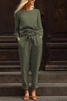 woman wearing olive green cotton-linen monochrome relaxed longline top and wide-leg pants set