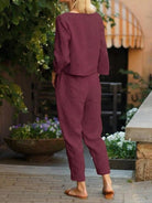 Woman wearing relaxed cotton-linen monochrome capsule outfit with longline top and wide-leg pants