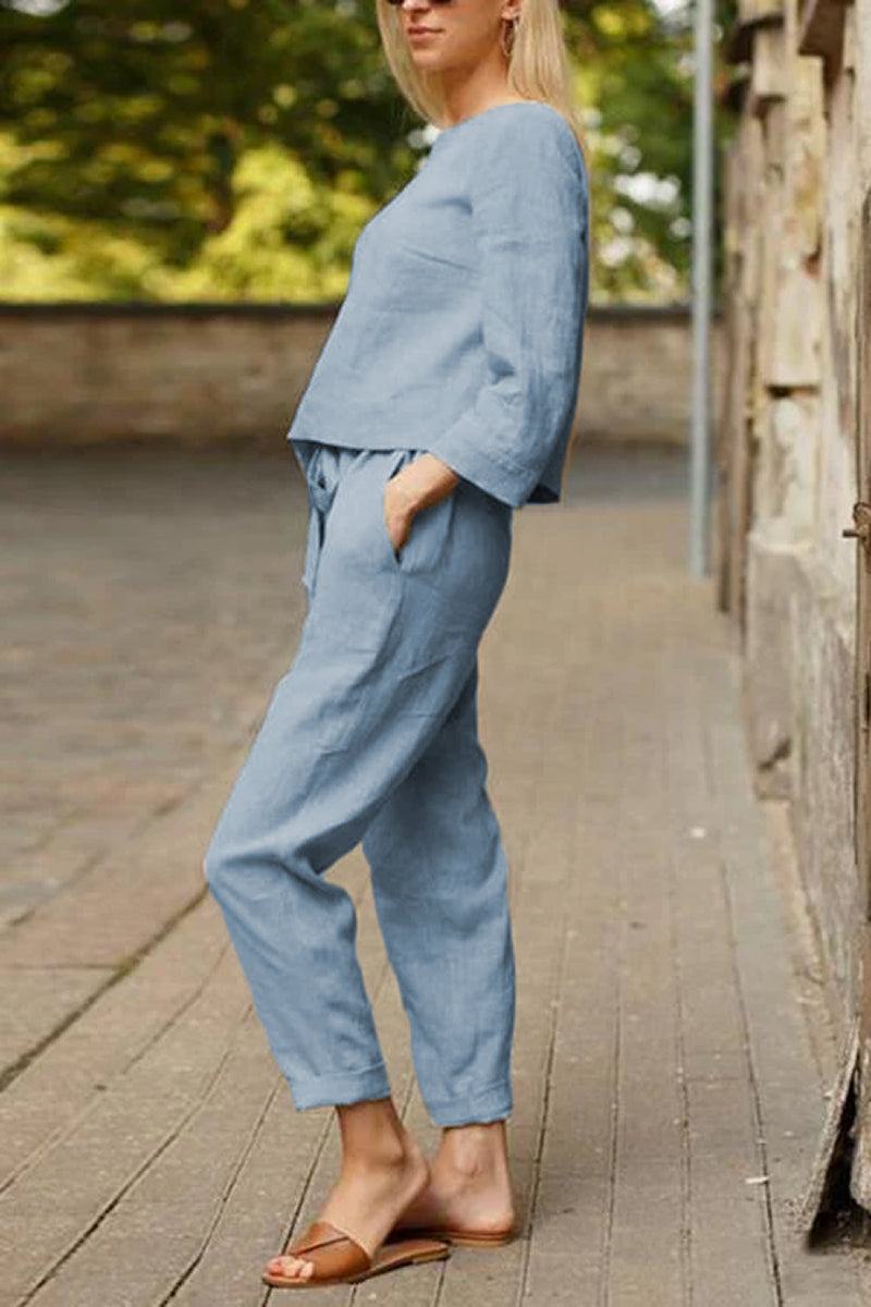 Woman wearing blue cotton-linen monochrome capsule outfit with relaxed longline top and wide-leg pants outdoors