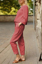Woman wearing relaxed cotton-linen monochrome longline top and wide-leg pants set in muted pink.