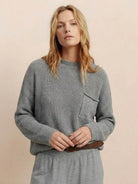 European minimalist relaxed gray knit sweater top with pocket detail paired with matching trousers
