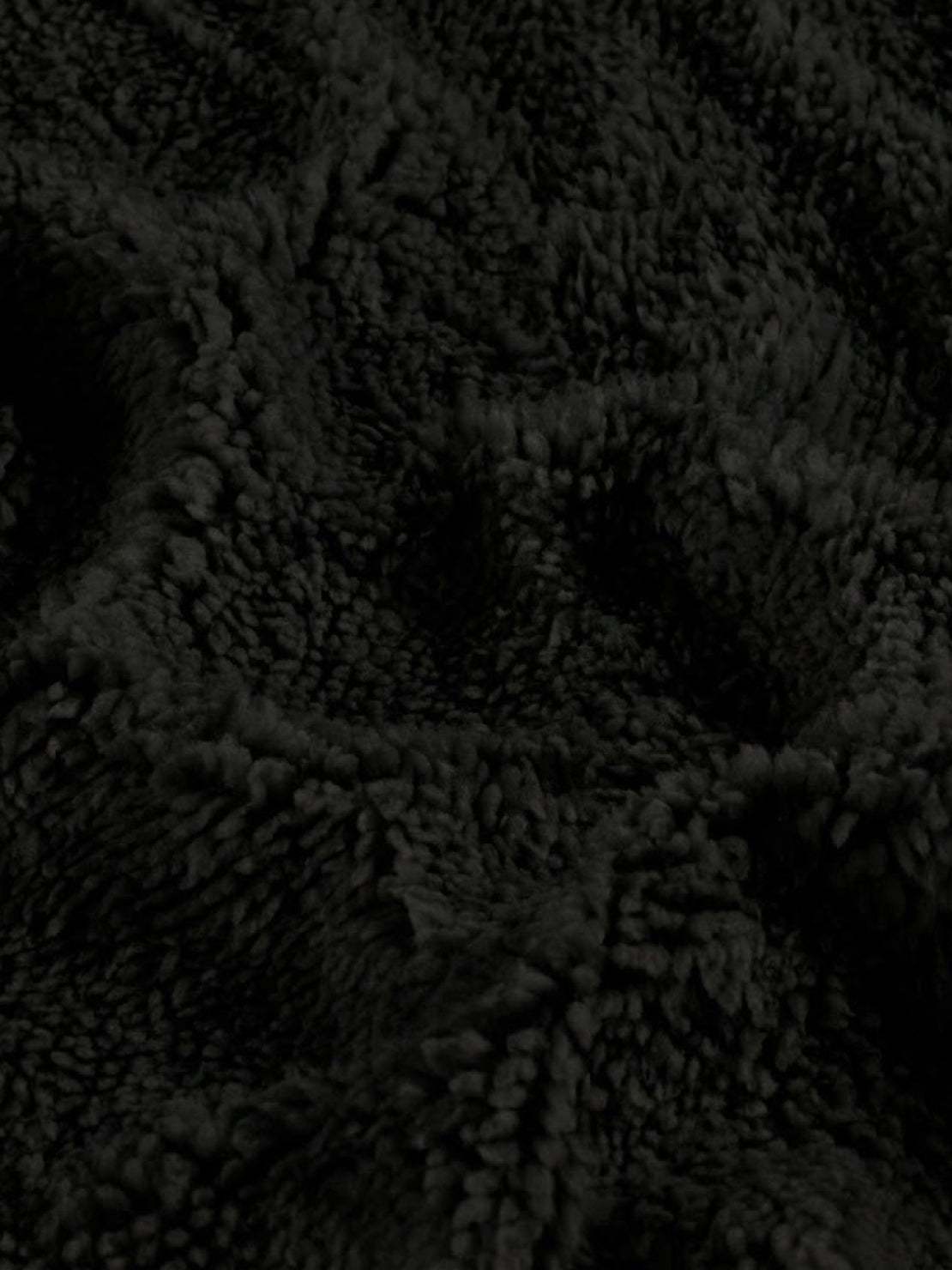 Close-up of soft black sherpa fabric texture for everyday wear oversized coat lining