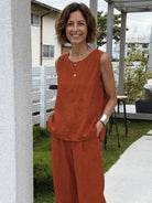 Loose solid color sleeveless two-piece set with oversized fit and relaxed wide-leg pants