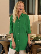 Oversized linen shirt in white with relaxed fit and button back detail on hanger