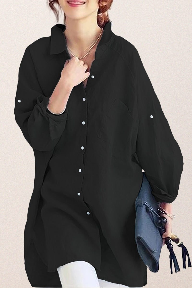 Black oversized linen shirt with relaxed fit and button details worn with white pants and blue clutch