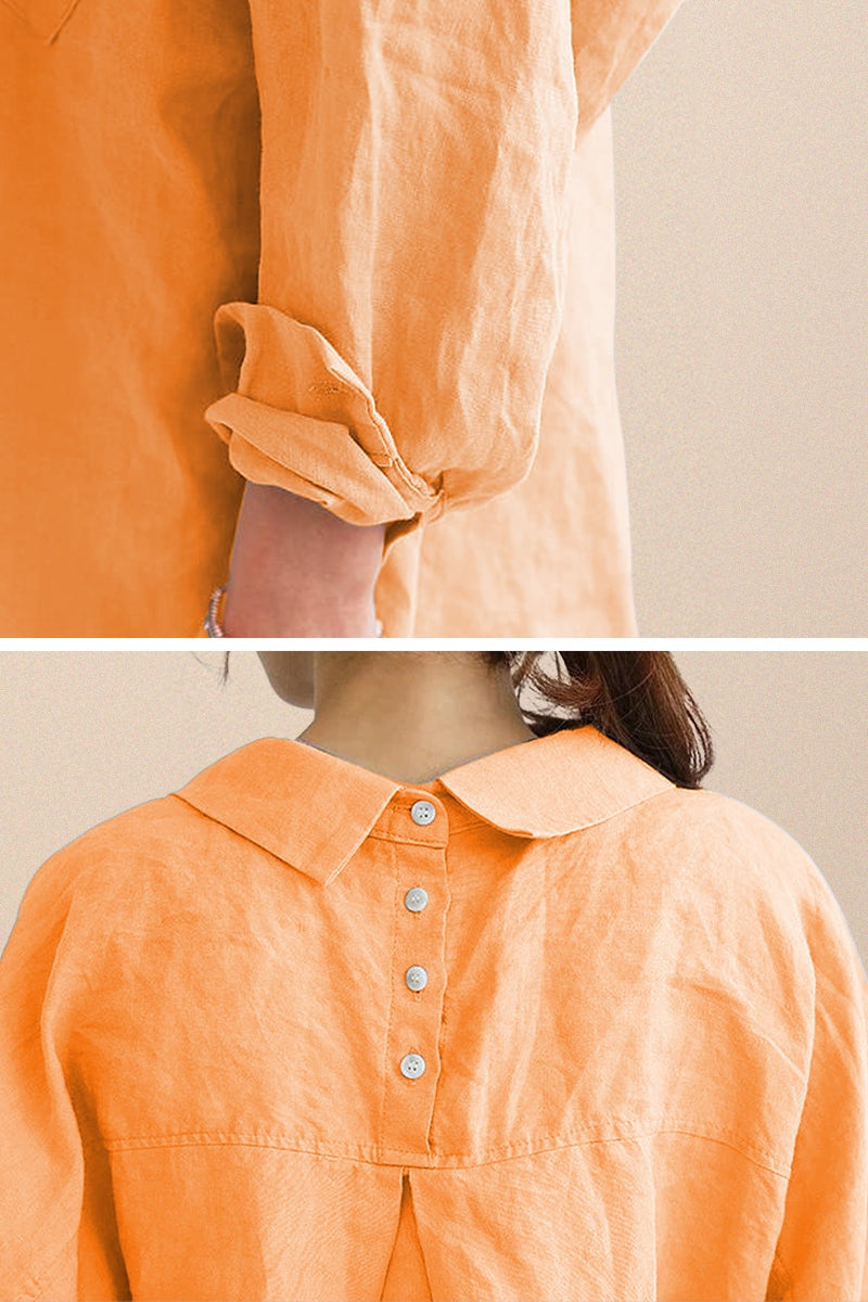 Close-up of oversized linen shirt sleeve and back button detailing in soft orange color