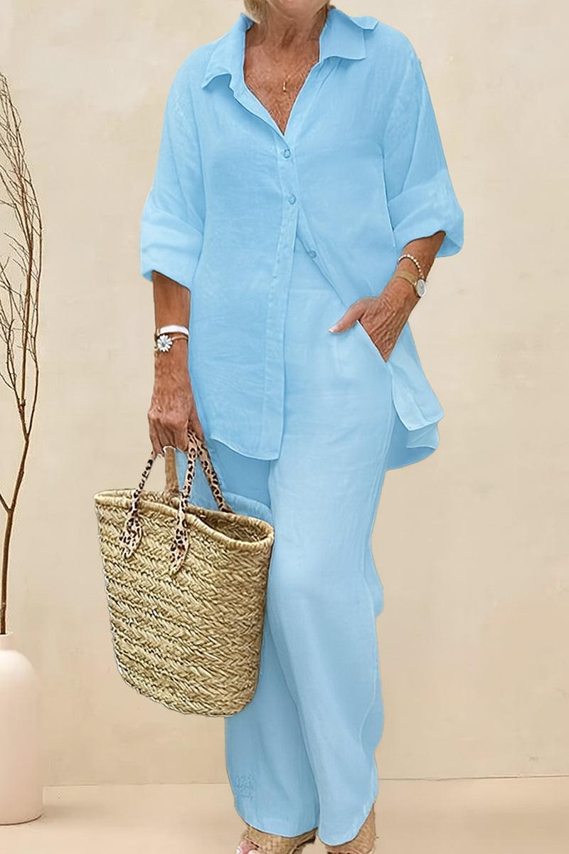 Light blue oversized 100% cotton shirt and wide-leg pants co-ord set modeled with natural woven bag