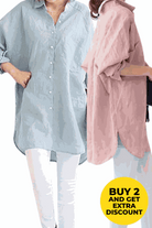 Two oversized linen shirts in light blue and dusty pink, styled casually with rolled-up sleeves and white pants, promoting a buy 2 discount offer.