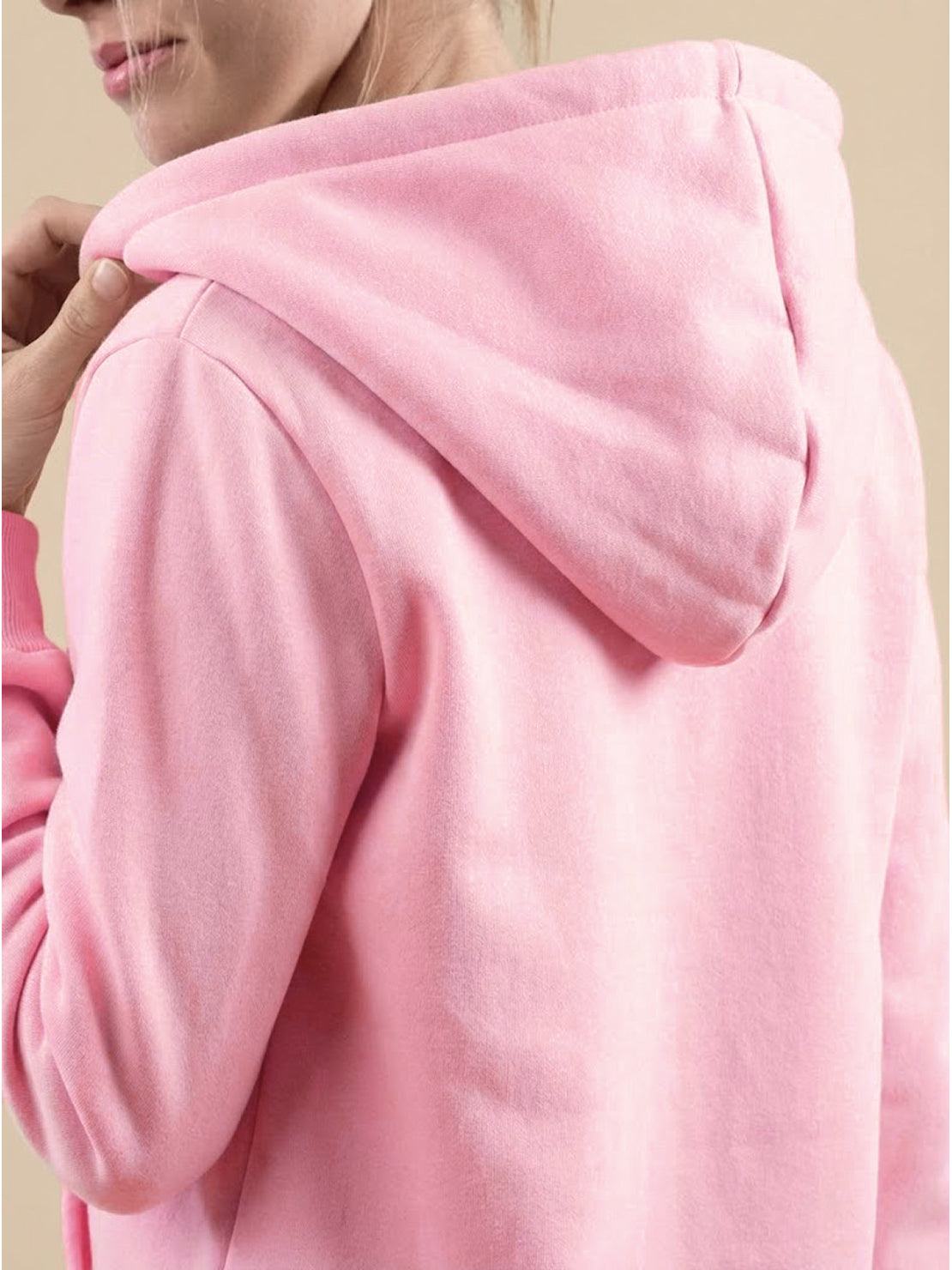 Close-up back view of a woman wearing a pink oversized long zip sweatshirt hoodie with a hood