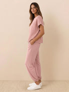 Woman wearing a Comfy Couture Knit Sweater two-piece set in a relaxed fit with matching knit pants