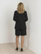 Woman wearing a stylish blazer and shorts two-piece set in a chic, comfortable outfit