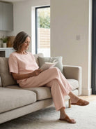 Woman wearing a loose fit co-ord set with soft-tailored top and wide-leg bottoms in a relaxed style