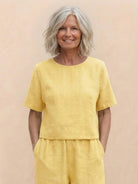 Woman wearing a loose fit co-ord set with a soft-tailored top and wide-leg bottoms in a relaxed, breathable fabric.