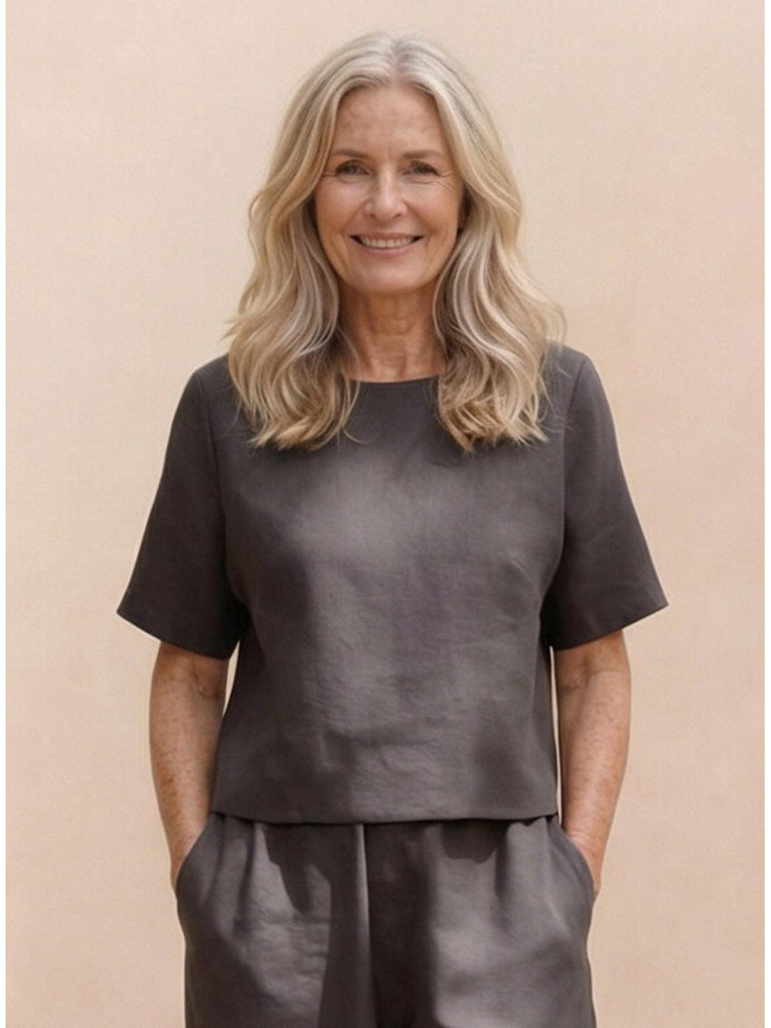 Woman wearing a loose fit co-ord set with relaxed top and wide-leg bottoms in neutral tones